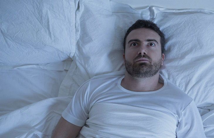 Man awake in bed image