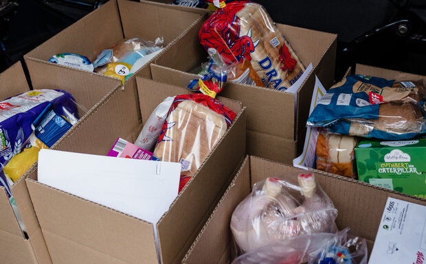 A selection of food is pictured in boxes ready to be distributed from a food bank.