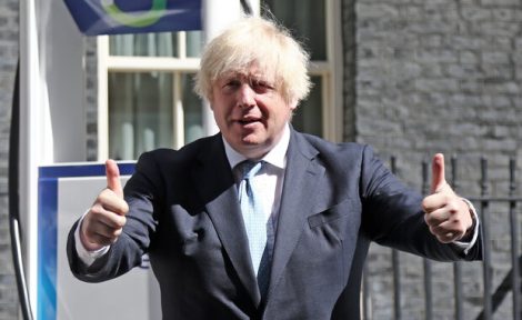Former Prime Minister Boris Johnson pictured in Downing Street with his thumbs up.