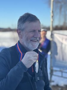 Paul Fosh pictured holding his medal at the end of his 500km Arctic challenge.