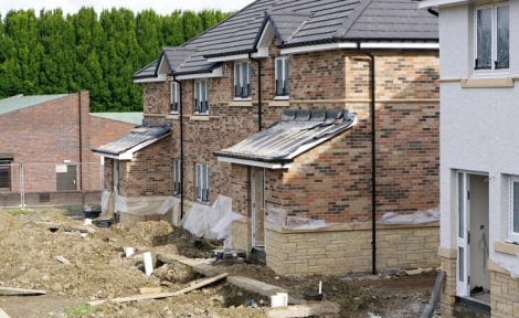 UK houses somewhere in suburbia are pictured under construction.