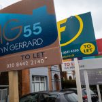 Four lettings sign boards are pictured in a posh London road.