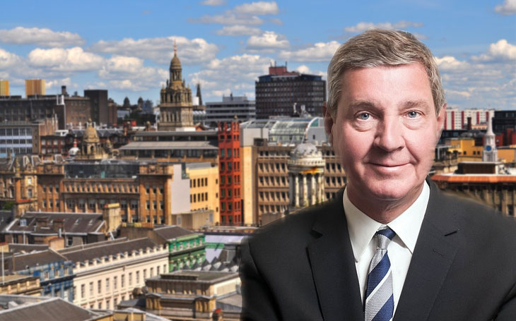 David Alexander of DJ Alexander Ltd in front of Glasgow skyline