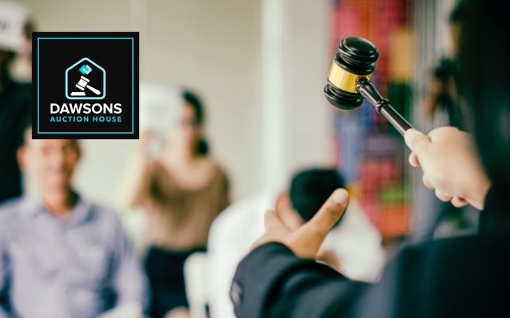 Auctioneer and blurred bidders