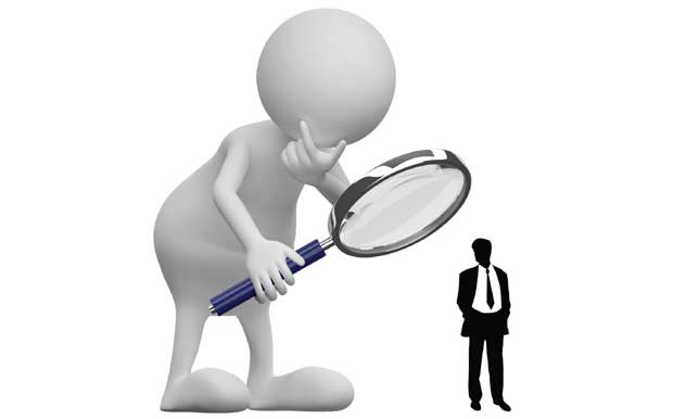 man under magnified glass image